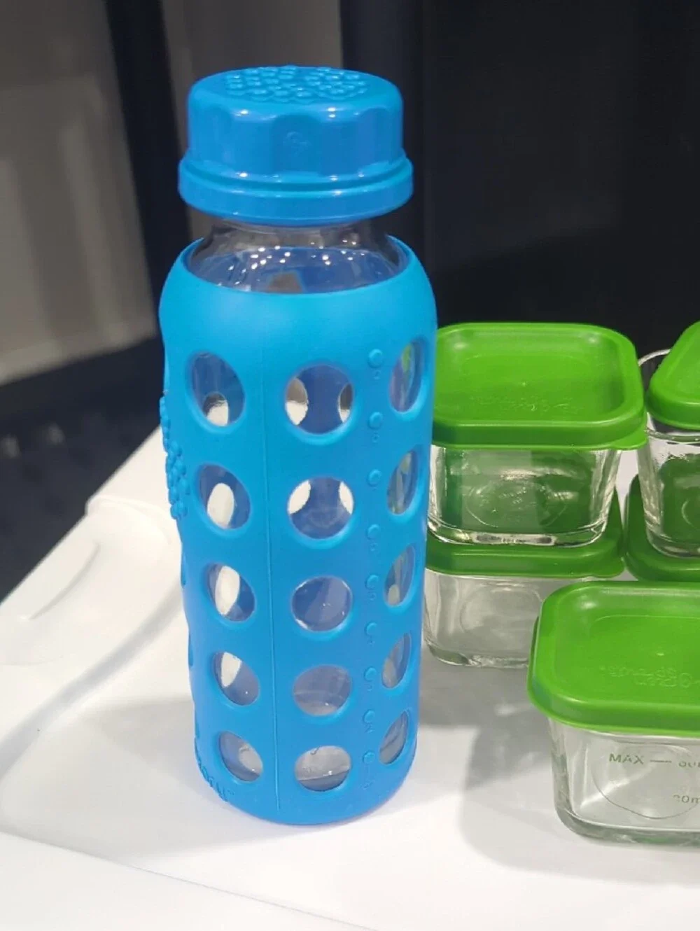 Glass Food Storage Set with Green Lids and Assorted Silicone Bottles